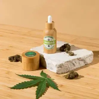 CBD oil product with cannabis leaf on a wooden surface